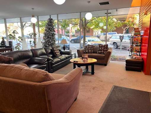 A living room with a brown couch and a coffee table.