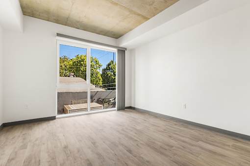 A room with a sliding glass door leading to a backyard.