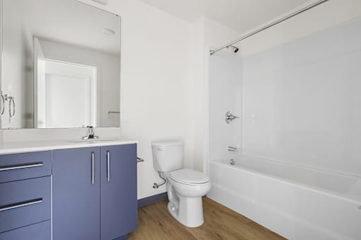 A white toilet sits next to a white sink in a bathroom.