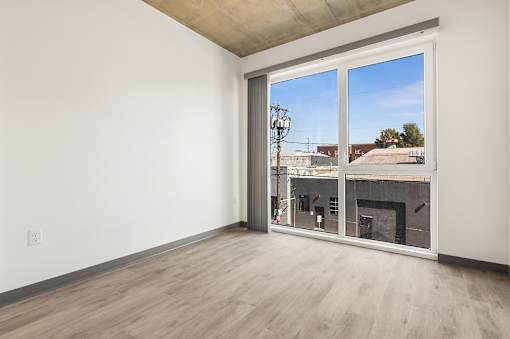 A room with a fireplace and a view of the outside through a large window.