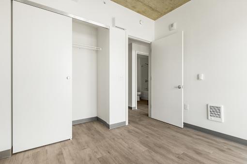 A white door is open to a hallway.