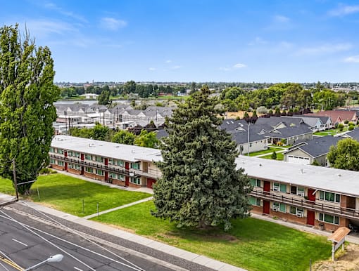 A view of a residential area with houses and trees.