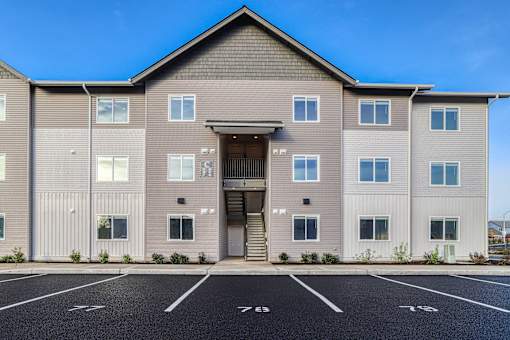 A large building with a parking lot in front of it.