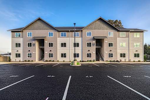 A large building with a parking lot in front of it.