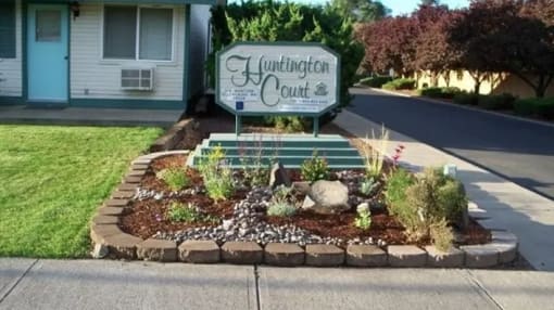 a landscaped front yard with a sign for the yukon court house