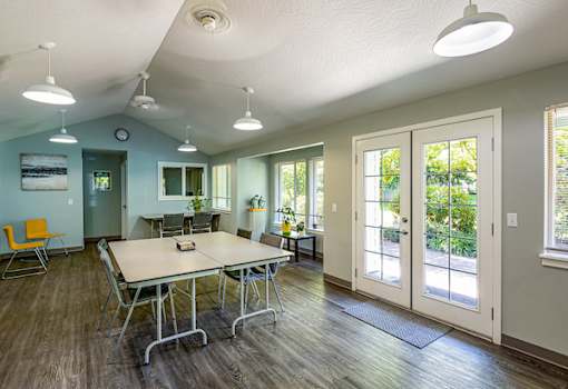 A conference room with a long table and chairs.