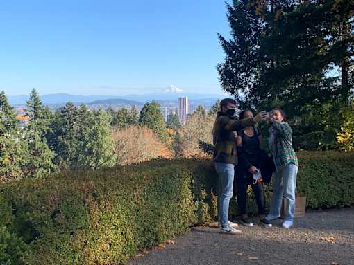 A group of people taking a selfie in a park.