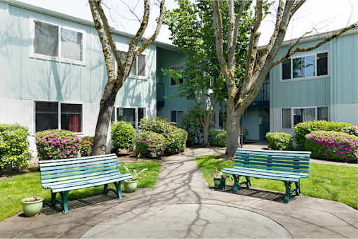 A green bench is in front of a building.