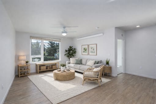 A living room with a couch, a chair, a table, and a rug.
