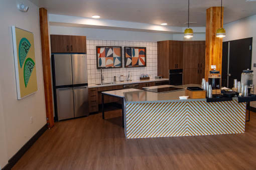 a large kitchen with a center island and stainless steel appliances
