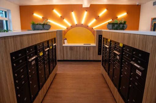 a card room with a bunch of mailboxes and a yellow light on the wall
