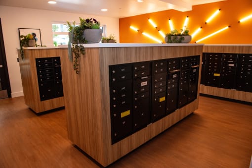 the lockers in the front of a room with yellow lights and a wooden floor