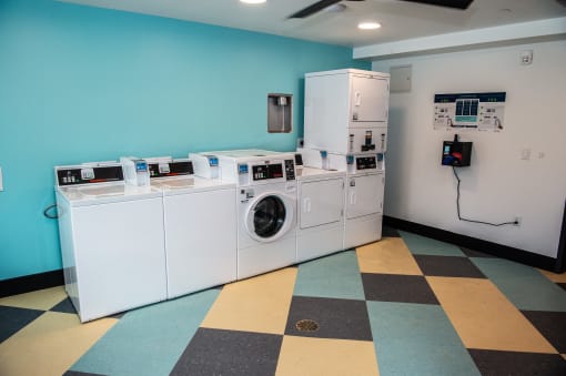 a laundry room with four washes and a washing machine