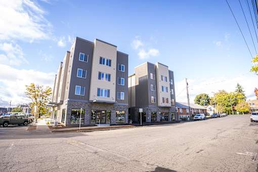 A street view of a row of modern apartment buildings.