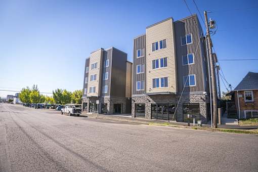 A street view of a residential area with apartment buildings.