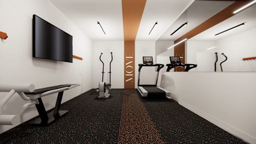 A gym with a row of treadmills and a television mounted on the wall.