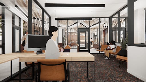 A person is sitting at a desk in a modern office space.