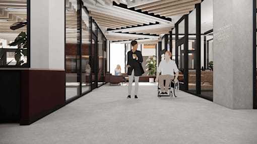 A woman in a wheelchair is being assisted by two other women in a modern hallway.