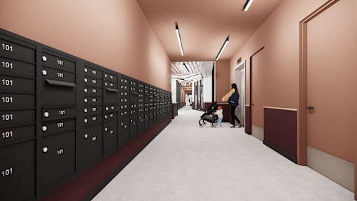 A hallway with a series of black lockers on the left and a woman pushing a stroller on the right.