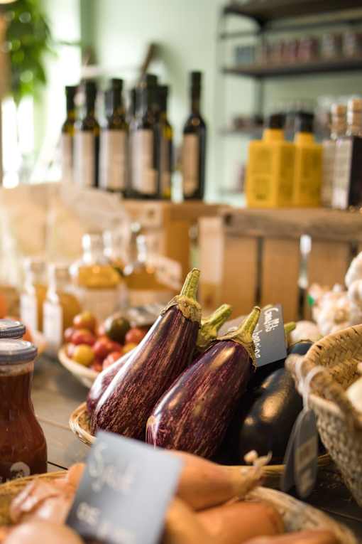 a display of eggplant and other produce at a farmers market
