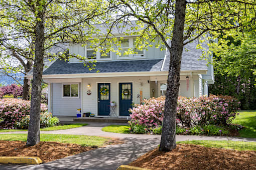A white house with a blue door and windows.