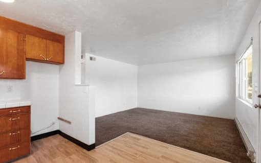 A room with wooden floors and white walls.