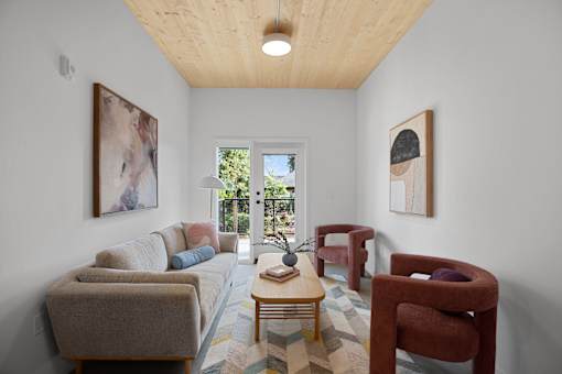 A living room with a couch, chairs, and a coffee table.