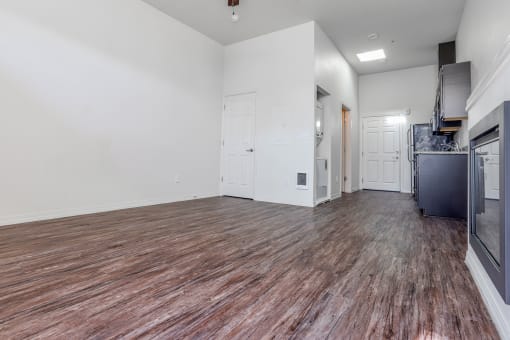 a bedroom with a medium sized bed and a kitchen with a stove and refrigerator