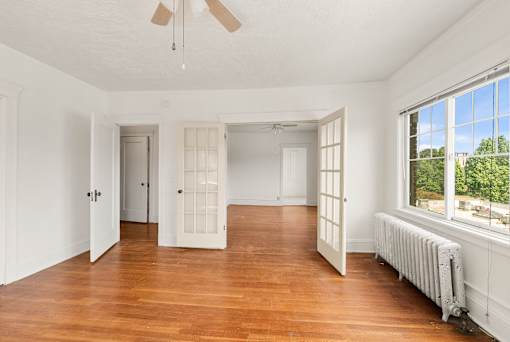 A room with wooden floors and white walls.