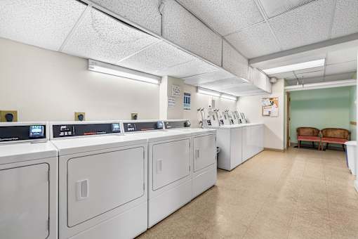 A laundry room with washers and dryers.