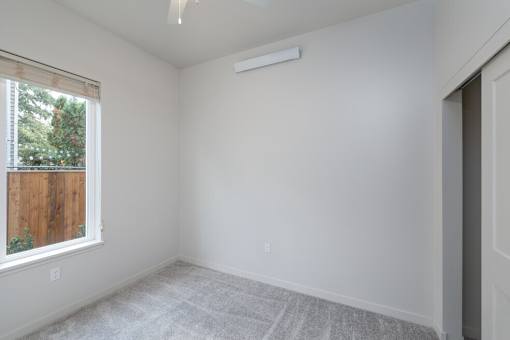A room with a window and a door.