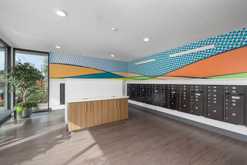 A modern office with a wooden reception desk and a wall of lockers.