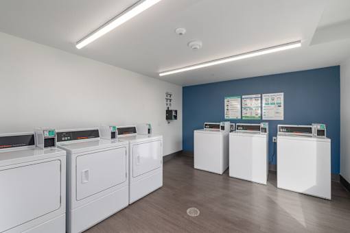 A row of washing machines in a laundromat.