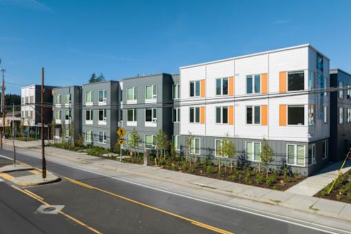 A street view of a residential area with apartment buildings.