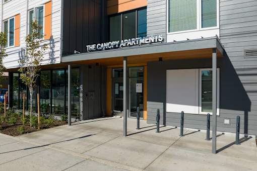 The Canopy Apartments is a modern building with a black and white exterior.