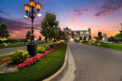 A street with a lamp post and a building in the background.