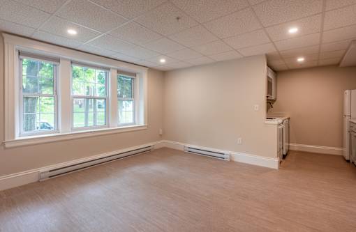 A room with a window and a wall-mounted air conditioner unit.