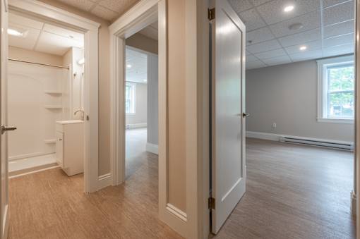 A room with a white door and a window.
