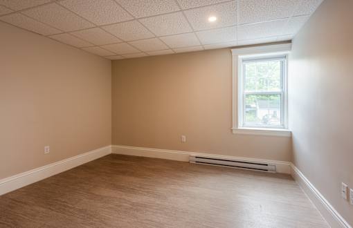 A room with a window and a radiator on the wall.