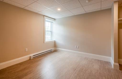 A room with a window and a radiator on the wall.