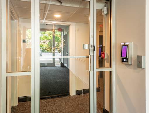 A glass door with a red sign on it.