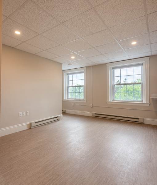 A room with a window and a wall socket.