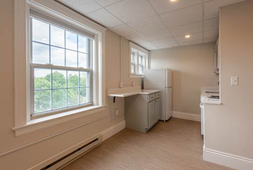 A kitchen with a window and a dishwasher.