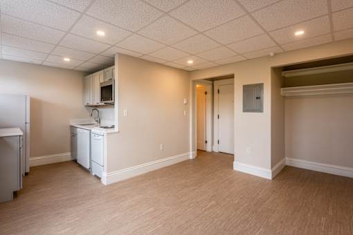 A kitchen area with a refrigerator, dishwasher, and cabinets.