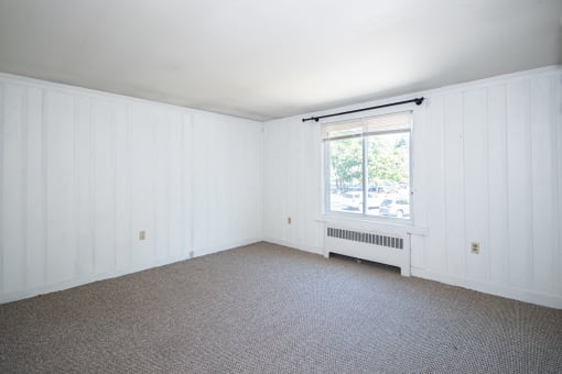 a bedroom with a radiator and a window