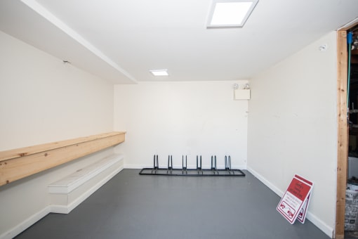 a room with a bench and a sign on the floor