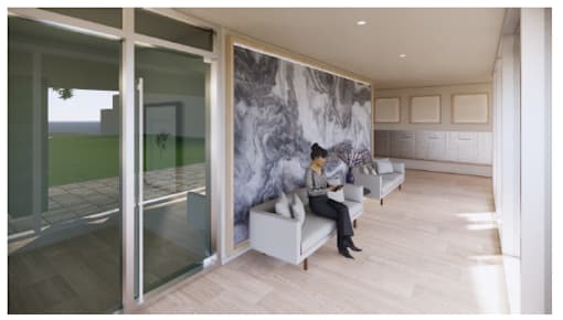 A person is sitting on a bench in a room with a marble wall.