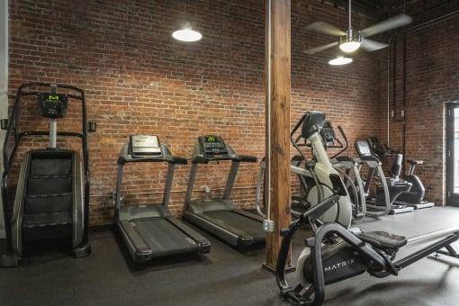 a gym with treadmills and ellipticals
