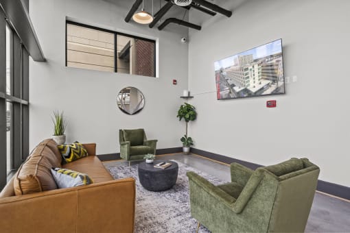 a living room with couches chairs and a coffee table at The Icon, Richmond, VA 23230