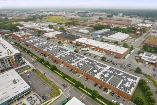 an aerial view of a parking lot and buildings in a city